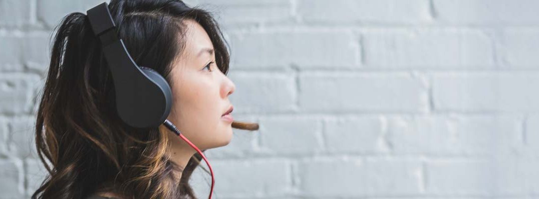 Woman listening through headphones