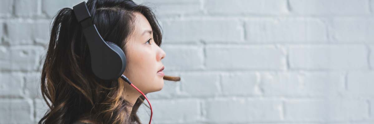 Woman listening through headphones